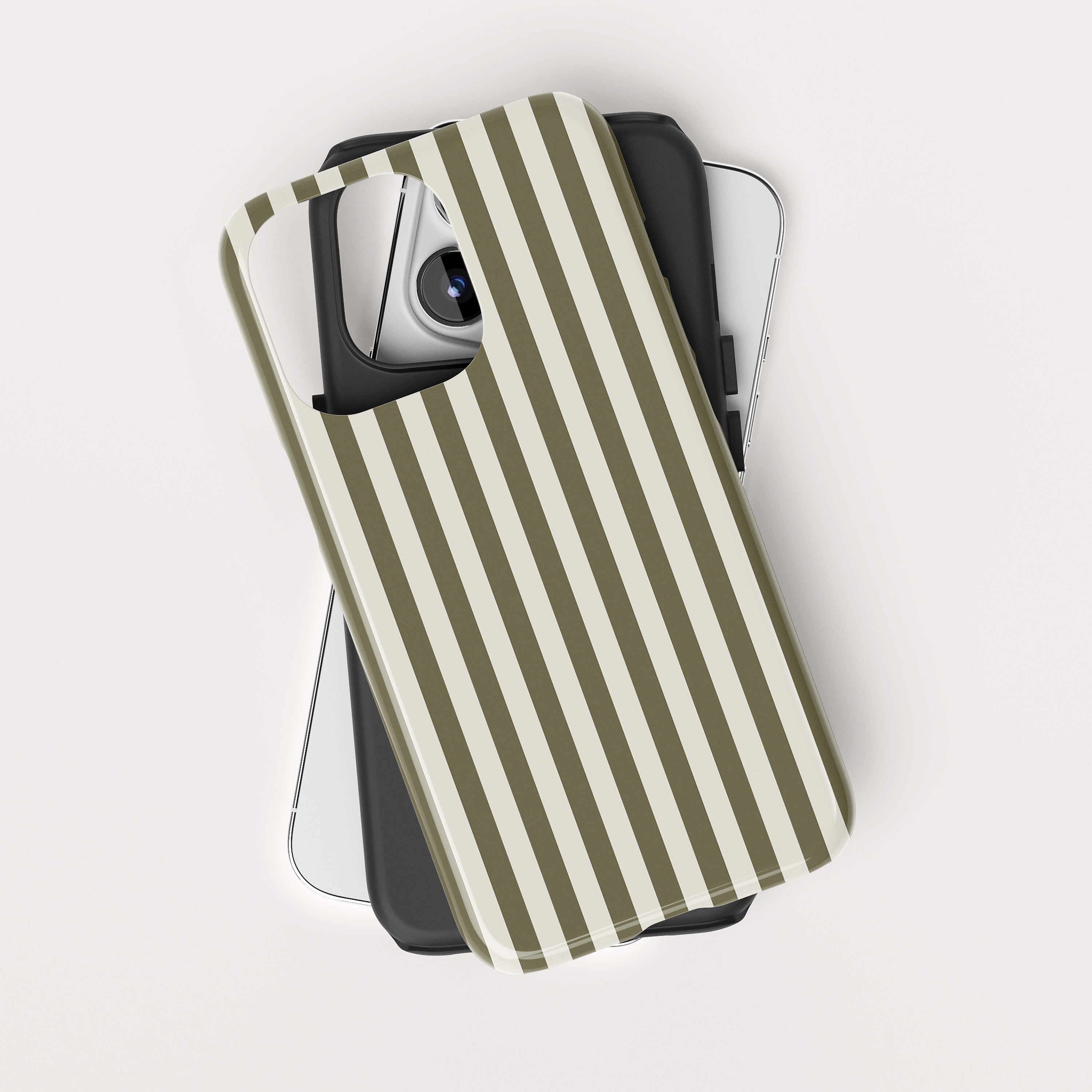 Olive green and cream vertical striped phone case resting on top of two sleek smartphone devices.